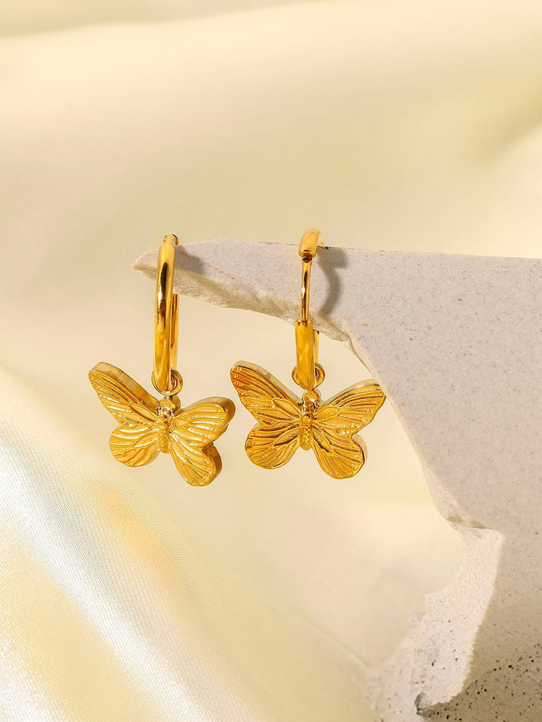Boucles d’oreilles papillon, créoles dorées, acier inoxydable, pendentif délicat, effet lumineux, modèle Pyra - Boucles d'oreilles - Or